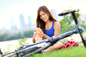 Knee pain bike injury. Woman with pain in knee joints after biki